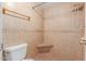Close-up of walk-in shower with tiled walls, and convenient built-in corner seat at 4510 W North Ln, Glendale, AZ 85302