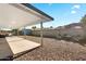 Spacious backyard with gravel, a covered patio, and a shed, offering ample outdoor space at 4645 E Covina St, Mesa, AZ 85205