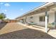 Large backyard with a covered patio, gravel landscaping, and a colorful hammock for relaxation at 4645 E Covina St, Mesa, AZ 85205