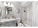 Bathroom featuring a shower over tub with tiled surround, white vanity, and modern lighting at 4645 E Covina St, Mesa, AZ 85205