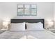 Bedroom featuring calming artwork above the bed, side tables with lamps, and light gray walls at 4645 E Covina St, Mesa, AZ 85205