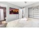 Bedroom features a TV, closet with shelving, and an ensuite bathroom with tiled shower at 4645 E Covina St, Mesa, AZ 85205