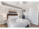 Bedroom featuring side tables with lamps, closet with shelving, wood-look flooring, and neutral walls at 4645 E Covina St, Mesa, AZ 85205