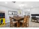 Dining room features a wooden table with six chairs, a modern light fixture, and a Pac-Personal arcade game at 4645 E Covina St, Mesa, AZ 85205