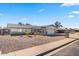 Well-maintained home featuring low-maintenance landscaping, a covered porch, and a two-car garage at 4645 E Covina St, Mesa, AZ 85205