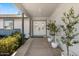 Inviting front porch with double doors, potted plants, and a well-maintained garden at 4645 E Covina St, Mesa, AZ 85205