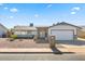 Charming single-story home featuring a manicured front yard and a two-car garage at 4645 E Covina St, Mesa, AZ 85205