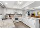 Kitchen featuring granite countertops, white cabinets, and modern appliances at 4645 E Covina St, Mesa, AZ 85205