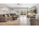 Spacious living room with a sectional sofa, sliding glass doors, and neutral decor at 4645 E Covina St, Mesa, AZ 85205