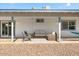 Relaxing covered patio featuring comfortable seating, soft lighting, and a view of the backyard at 4645 E Covina St, Mesa, AZ 85205