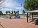 A playground area with swings, slides, and picnic tables, perfect for outdoor activities and gatherings at 4645 E Covina St, Mesa, AZ 85205
