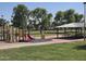 A colorful playground area with a slide and picnic tables in a well-maintained community park at 4645 E Covina St, Mesa, AZ 85205