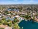 An aerial view of the real estate property, showcasing its proximity to a lake, tennis courts, and the surrounding neighborhood at 5200 S Lakeshore Dr # 120, Tempe, AZ 85283