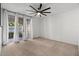 Spacious bedroom with ceiling fan, neutral carpet, and sliding glass door to backyard at 5200 S Lakeshore Dr # 120, Tempe, AZ 85283