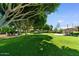 Expansive green common area with mature trees and outdoor seating, perfect for relaxation and recreation at 5200 S Lakeshore Dr # 120, Tempe, AZ 85283