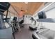 Well-equipped fitness center with treadmills, elliptical machines, and a wood-paneled ceiling at 5200 S Lakeshore Dr # 120, Tempe, AZ 85283