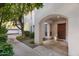 Charming front entrance featuring a solid wood door, complemented by lush landscaping and walkway at 5200 S Lakeshore Dr # 120, Tempe, AZ 85283