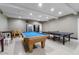 Well-lit game room with a pool table, ping pong table, foosball, and vending machines at 5200 S Lakeshore Dr # 120, Tempe, AZ 85283