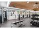 Fully equipped gym with weight machines, free weights, and a wood-paneled ceiling at 5200 S Lakeshore Dr # 120, Tempe, AZ 85283
