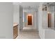Bright hallway with neutral carpet, leading to various rooms and a beautifully designed front door at 5200 S Lakeshore Dr # 120, Tempe, AZ 85283