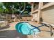 Inviting hot tub with clear water and seating, surrounded by a brick patio and lush landscaping at 5200 S Lakeshore Dr # 120, Tempe, AZ 85283