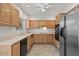 Spacious kitchen with light wood cabinets, stainless steel appliances, and tile flooring at 5200 S Lakeshore Dr # 120, Tempe, AZ 85283