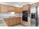 Bright kitchen with light wood cabinets, stainless steel appliances, and tile flooring at 5200 S Lakeshore Dr # 120, Tempe, AZ 85283