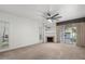Bright living room featuring neutral carpet, fireplace, ceiling fan, and sliding glass door at 5200 S Lakeshore Dr # 120, Tempe, AZ 85283