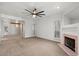 Spacious living room with neutral carpet, fireplace, ceiling fan, and natural light at 5200 S Lakeshore Dr # 120, Tempe, AZ 85283