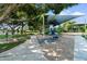 Well-maintained playground with slides and swings, set in a sandy area with shaded seating nearby at 5200 S Lakeshore Dr # 120, Tempe, AZ 85283