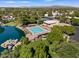 A community pool with boats docked along the lake's edge is surrounded by lush green trees at 5200 S Lakeshore Dr # 120, Tempe, AZ 85283