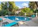 Large rectangular pool surrounded by lounge chairs, with trees providing shade and privacy at 5200 S Lakeshore Dr # 120, Tempe, AZ 85283