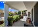 Spacious covered back patio with outdoor seating and lush greenery, perfect for relaxing at 5341 W Bloomfield Rd, Glendale, AZ 85304