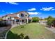 Large backyard featuring lush green grass, established trees, and a two-story home at 5341 W Bloomfield Rd, Glendale, AZ 85304