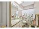 Clean bathroom with granite counters, neutral colors and floral shower curtain at 5341 W Bloomfield Rd, Glendale, AZ 85304