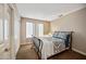 Cozy bedroom with neutral walls, carpet, and a comfortable bed near a sunny window at 5341 W Bloomfield Rd, Glendale, AZ 85304