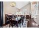Spacious dining room with dark wood floors, large windows, and a decorative chandelier at 5341 W Bloomfield Rd, Glendale, AZ 85304