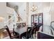 Open dining area with hardwood floors, chandelier, staircase, and view of front yard at 5341 W Bloomfield Rd, Glendale, AZ 85304