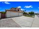 Attractive home showcasing a spacious driveway, a three-car garage, and low-maintenance landscaping at 5341 W Bloomfield Rd, Glendale, AZ 85304