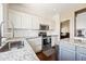 Bright kitchen featuring stainless steel appliances, granite counters, subway tile backsplash, and dark wood floors at 5341 W Bloomfield Rd, Glendale, AZ 85304