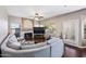 Cozy living room with fireplace, ceiling fan, plush seating, and access to the backyard at 5341 W Bloomfield Rd, Glendale, AZ 85304