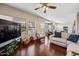 Open living room with wood floors, ceiling fan, neutral walls, and an abundance of natural light at 5341 W Bloomfield Rd, Glendale, AZ 85304