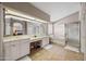 Main bathroom features dual sinks, vanity and a walk-in shower at 5341 W Bloomfield Rd, Glendale, AZ 85304