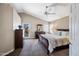 Cozy main bedroom featuring vaulted ceilings, ceiling fan and a private patio access at 5341 W Bloomfield Rd, Glendale, AZ 85304