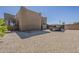 Gravel backyard with a trailer parked along the property line and the home's exterior at 5630 E Peak View Rd, Cave Creek, AZ 85331