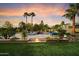 Resort-style backyard with lush landscaping, pool, waterfall, and outdoor seating at 5630 E Peak View Rd, Cave Creek, AZ 85331