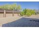 Gravel backyard featuring mature desert landscaping, a fire pit, and ample private space at 5630 E Peak View Rd, Cave Creek, AZ 85331