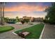 Expansive backyard featuring a horseshoe pit and lounge area against a beautiful Southwestern home at sunset at 5630 E Peak View Rd, Cave Creek, AZ 85331