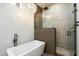 Modern bathroom featuring a freestanding tub and a glass-enclosed shower with herringbone tile at 5630 E Peak View Rd, Cave Creek, AZ 85331