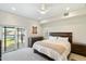 Bright bedroom with light colored carpet, access to patio, and ensuite bathroom at 5630 E Peak View Rd, Cave Creek, AZ 85331